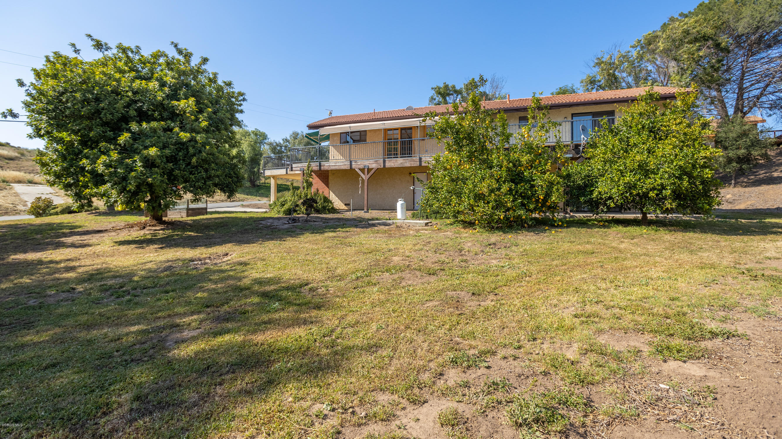 7240 Studio Road Canoga Park, CA 91304 - Photo 15 of 19 a view of a house with a yard and potted plants