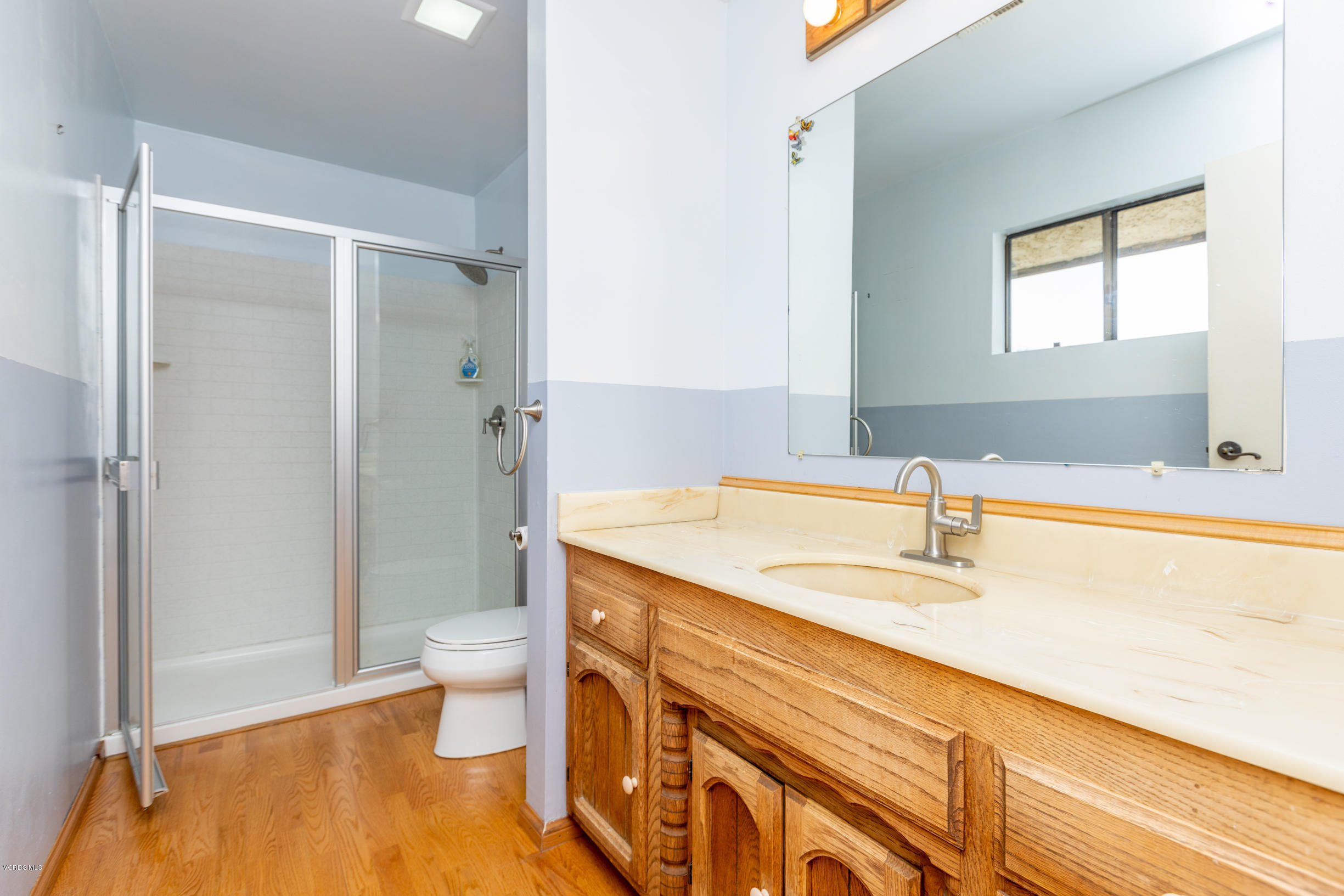 7240 Studio Road Canoga Park, CA 91304 - Photo 10 of 19 a bathroom with a sink and a large mirror