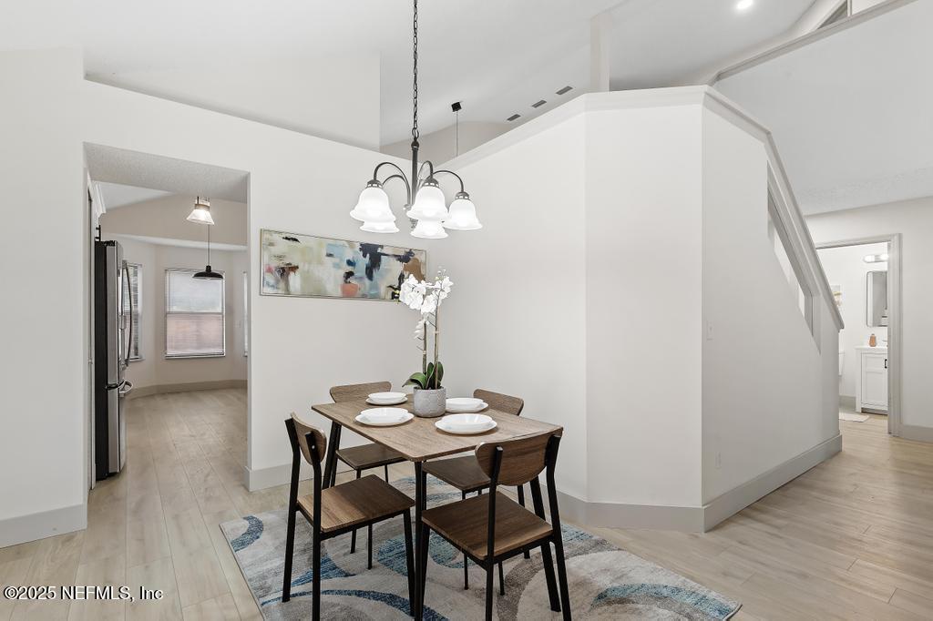 5497 Spring Brook Road Jacksonville, FL 32277 - Photo 11 of 54 a view of a dining room with furniture and wooden floor