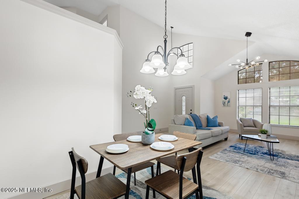5497 Spring Brook Road Jacksonville, FL 32277 - Photo 12 of 54 a view of a dining room with furniture a rug and wooden floor