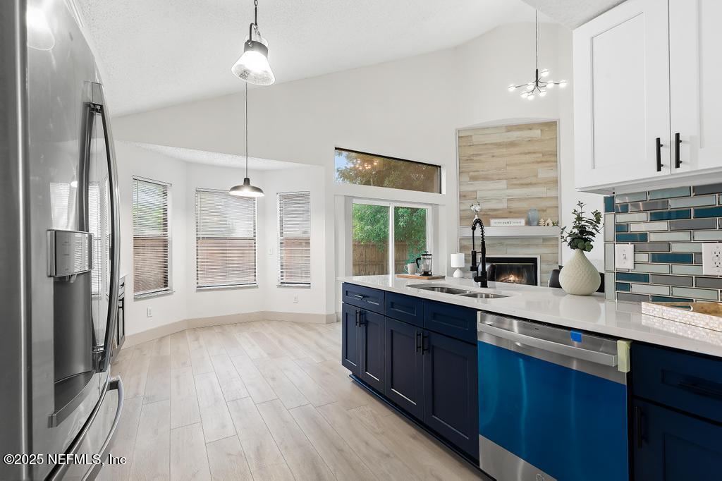 5497 Spring Brook Road Jacksonville, FL 32277 - Photo 13 of 54 a kitchen with stainless steel appliances granite countertop a sink refrigerator and cabinets