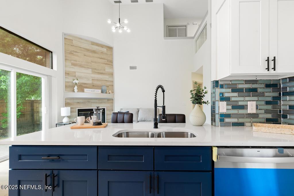 5497 Spring Brook Road Jacksonville, FL 32277 - Photo 14 of 54 a kitchen with a sink and a potted plant