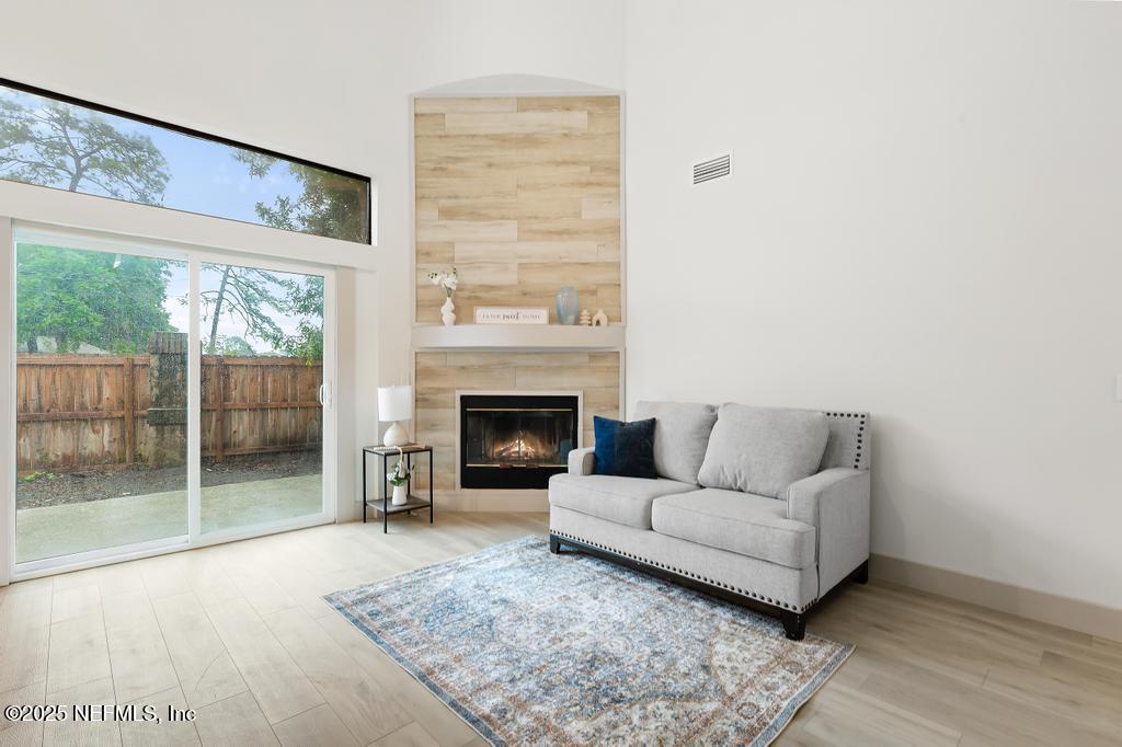 5497 Spring Brook Road Jacksonville, FL 32277 - Photo 20 of 54 a living room with furniture and a fireplace