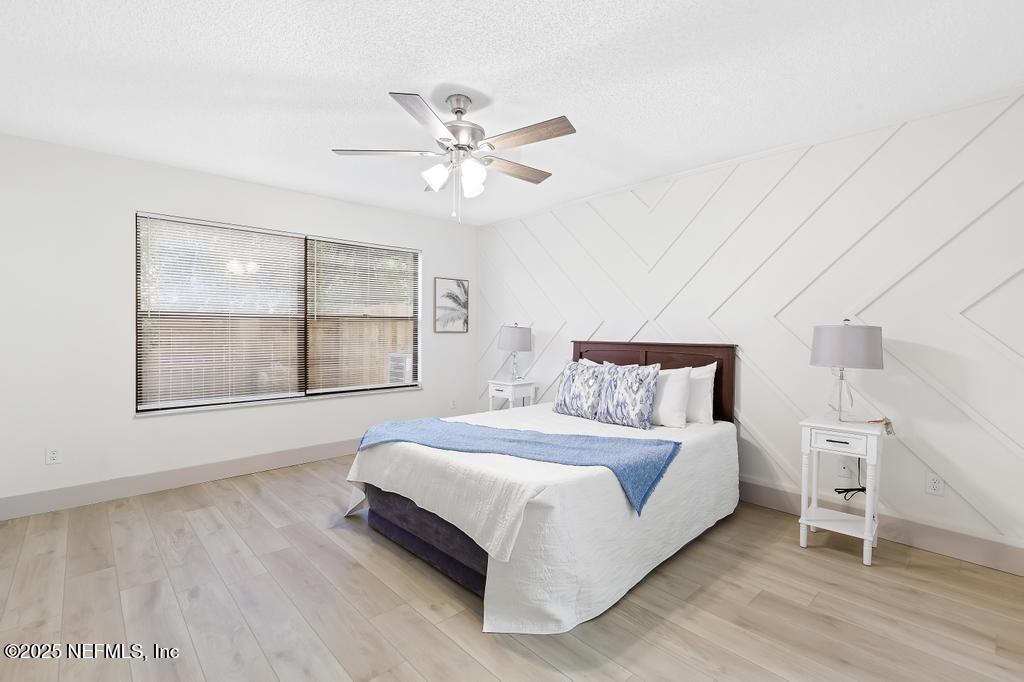 5497 Spring Brook Road Jacksonville, FL 32277 - Photo 22 of 54 a spacious bedroom with a bed and a window