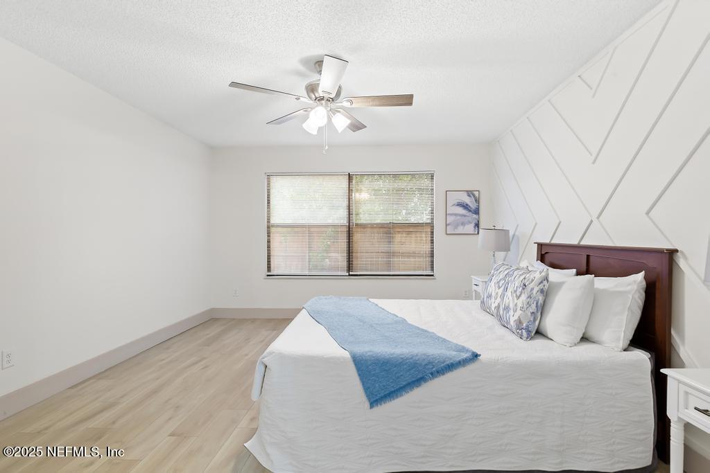 5497 Spring Brook Road Jacksonville, FL 32277 - Photo 25 of 54 a bedroom with a large bed and a window