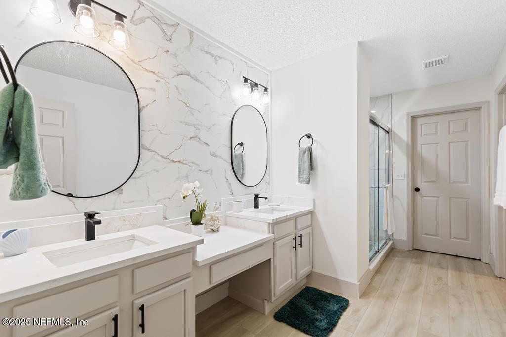 5497 Spring Brook Road Jacksonville, FL 32277 - Photo 26 of 54 a bathroom with a double vanity sink and a mirror