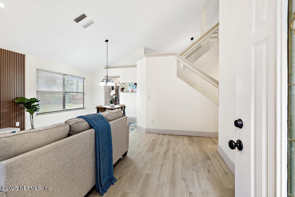 5497 Spring Brook Road Jacksonville, FL 32277 - Photo 3 of 54 a living room with furniture and wooden floor