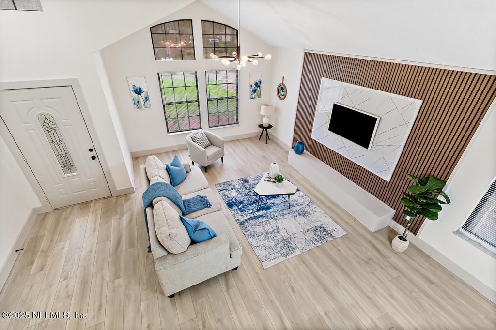 5497 Spring Brook Road Jacksonville, FL 32277 - Photo 36 of 54 a living room with furniture and a flat screen tv