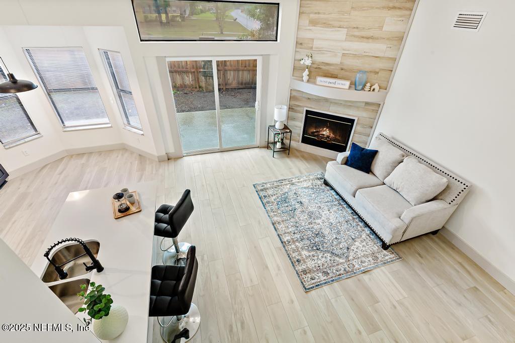 5497 Spring Brook Road Jacksonville, FL 32277 - Photo 38 of 54 a living room with furniture and a fireplace
