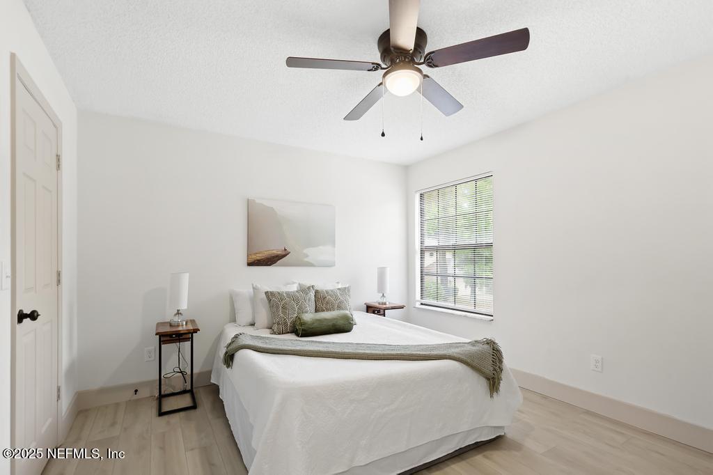 5497 Spring Brook Road Jacksonville, FL 32277 - Photo 43 of 54 a bedroom with a bed and a window