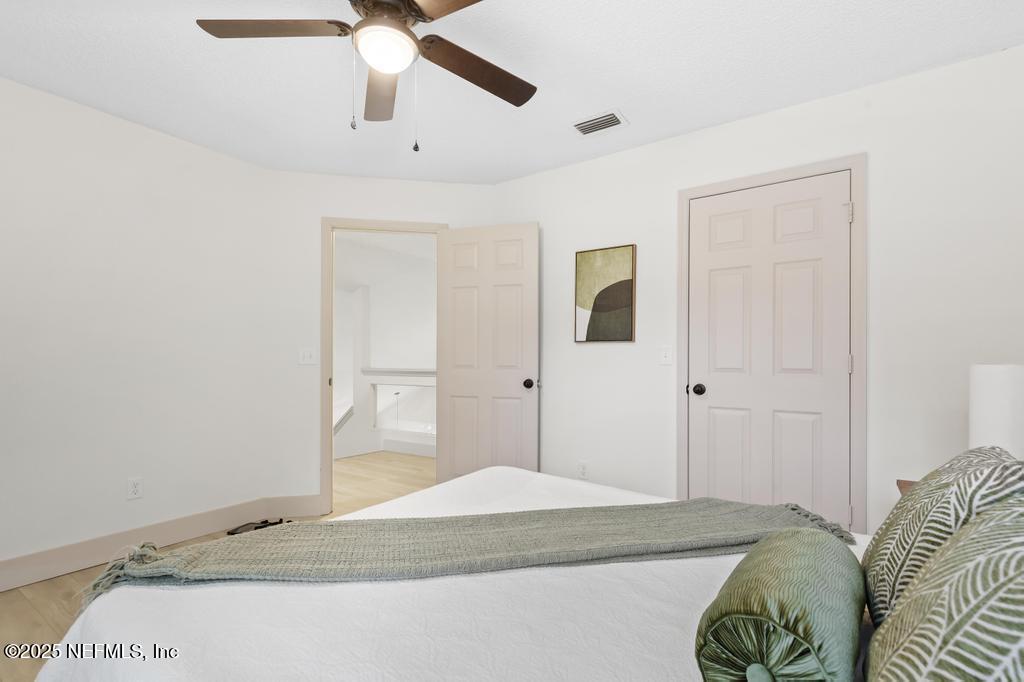 5497 Spring Brook Road Jacksonville, FL 32277 - Photo 44 of 54 a bedroom with a bed and a chandelier