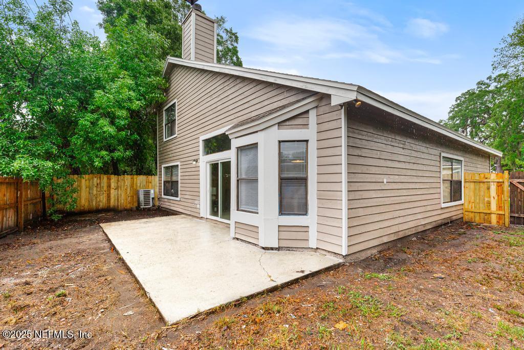 5497 Spring Brook Road Jacksonville, FL 32277 - Photo 49 of 54 a view of house with wooden fence