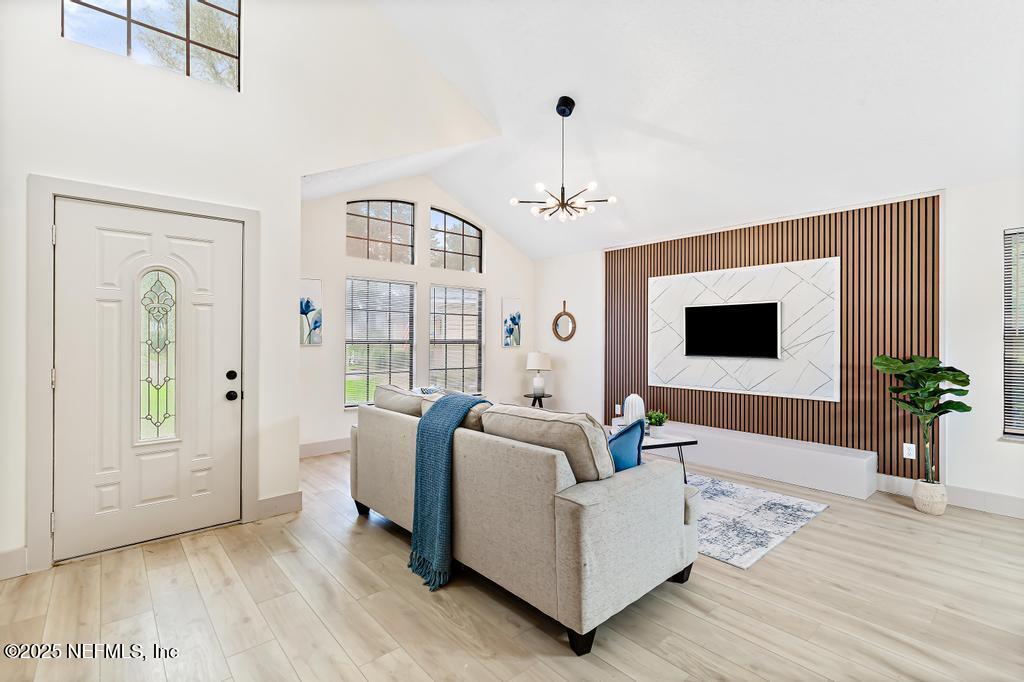 5497 Spring Brook Road Jacksonville, FL 32277 - Photo 5 of 54 a living room with furniture and a flat screen tv