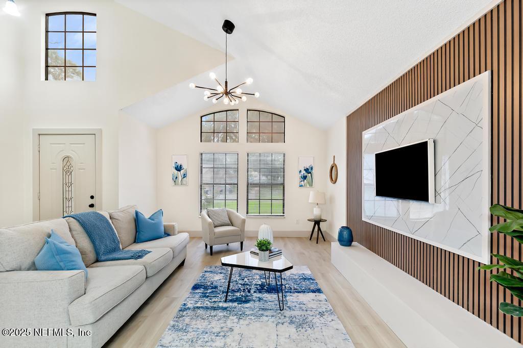 5497 Spring Brook Road Jacksonville, FL 32277 - Photo 7 of 54 a living room with furniture and a flat screen tv