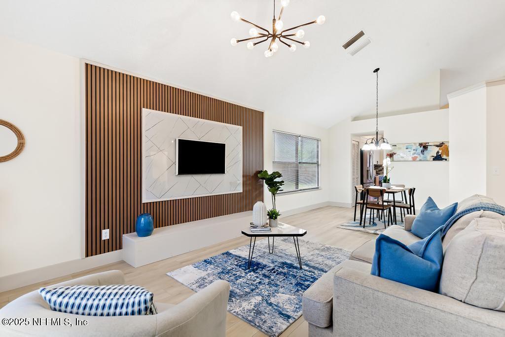5497 Spring Brook Road Jacksonville, FL 32277 - Photo 10 of 54 a living room with furniture and a fireplace
