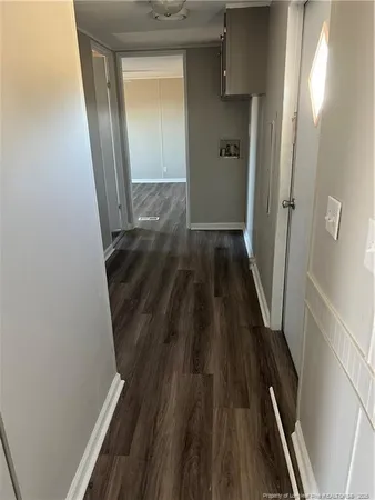 a view of a hallway and wooden floor