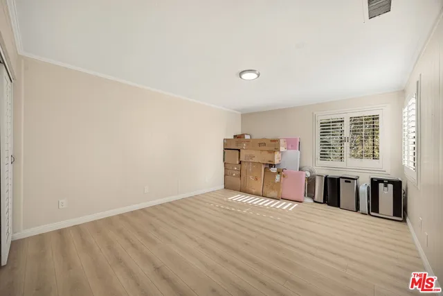 a big room with wooden floor and windows