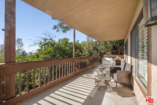 a view of balcony with wooden floor and bench
