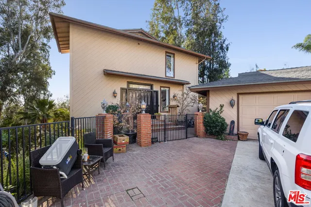 a view of a patio with couches chairs and backyard