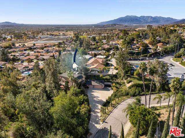 an aerial view of residential house with outdoor space and trees