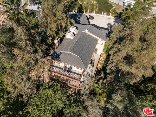 an aerial view of a house with a yard