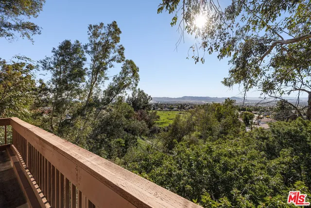 a view of a forest from a balcony