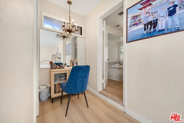 a view of a workspace with furniture and a chandelier