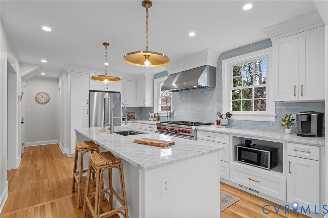 1017 Ridge Top Road Henrico, VA 23229 - Photo 11 of 37 a kitchen with kitchen island a stove a sink a center island and windows