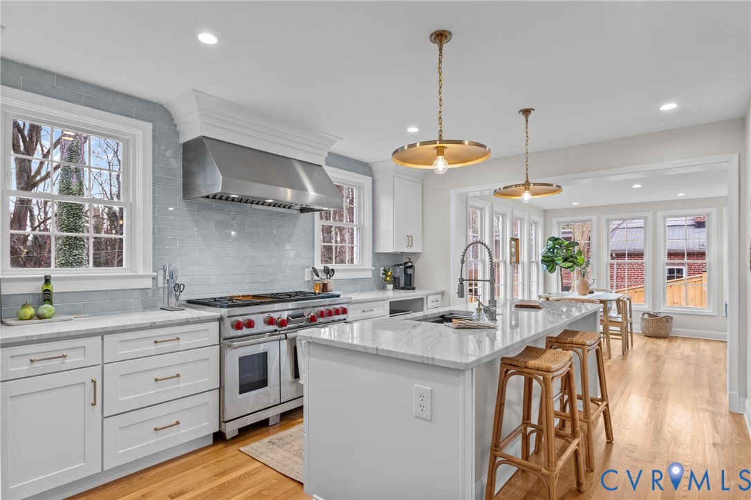 1017 Ridge Top Road Henrico, VA 23229 - Photo 13 of 37 a kitchen with stainless steel appliances granite countertop a stove a sink and a wooden floors