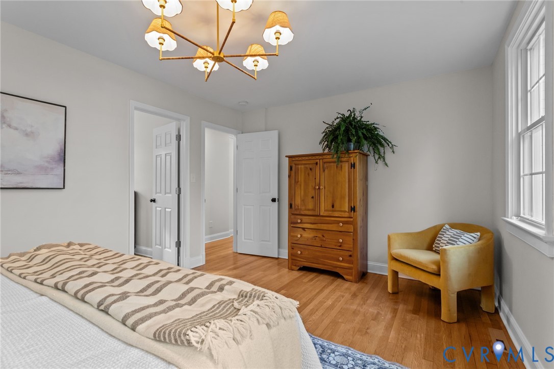 1017 Ridge Top Road Henrico, VA 23229 - Photo 17 of 37 a bedroom with a bed and a chandelier