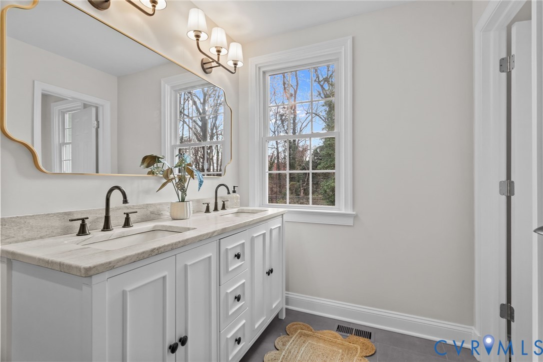 1017 Ridge Top Road Henrico, VA 23229 - Photo 18 of 37 a bathroom with a sink a vanity and a mirror