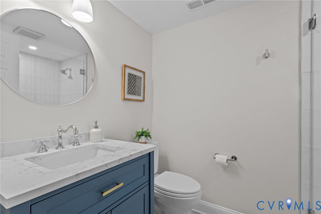 1017 Ridge Top Road Henrico, VA 23229 - Photo 30 of 37 a bathroom with a granite countertop sink a toilet and a mirror