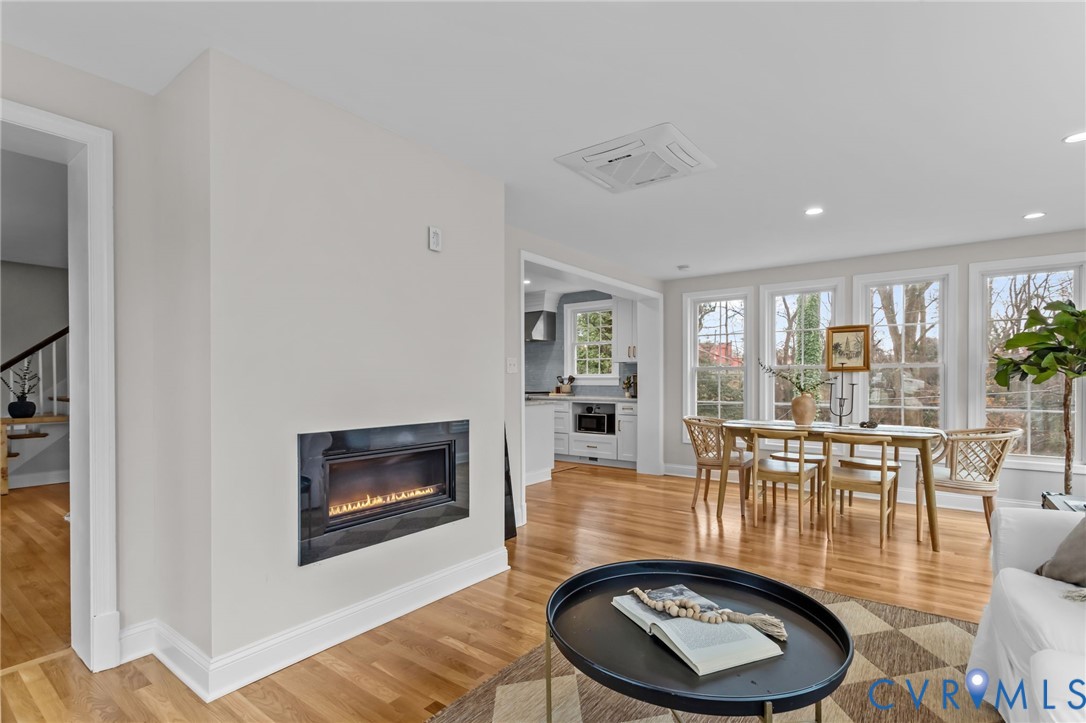 1017 Ridge Top Road Henrico, VA 23229 - Photo 7 of 37 a dining room with furniture wooden floor a rug and a painting