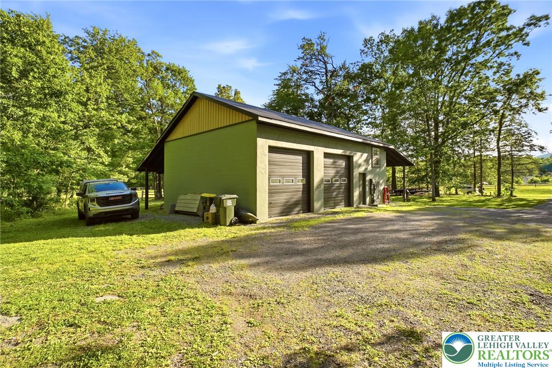 9033 Loop Road Slatington, PA 18080 - Photo 16 of 53 A detached two-bay garage with gravel driveway offers ample storage and utility space.