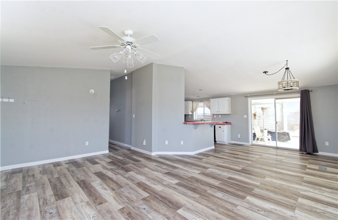 49603 Rainbow Avenue Quartzsite, AZ 85346 - Photo 11 of 44 Unfurnished living room with light wood-type flooring and ceiling fan