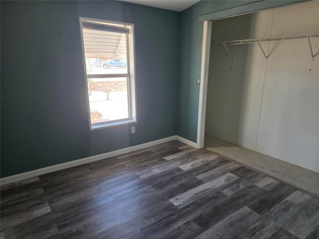 49603 Rainbow Avenue Quartzsite, AZ 85346 - Photo 20 of 44 Unfurnished bedroom featuring a closet and dark wood-style floors