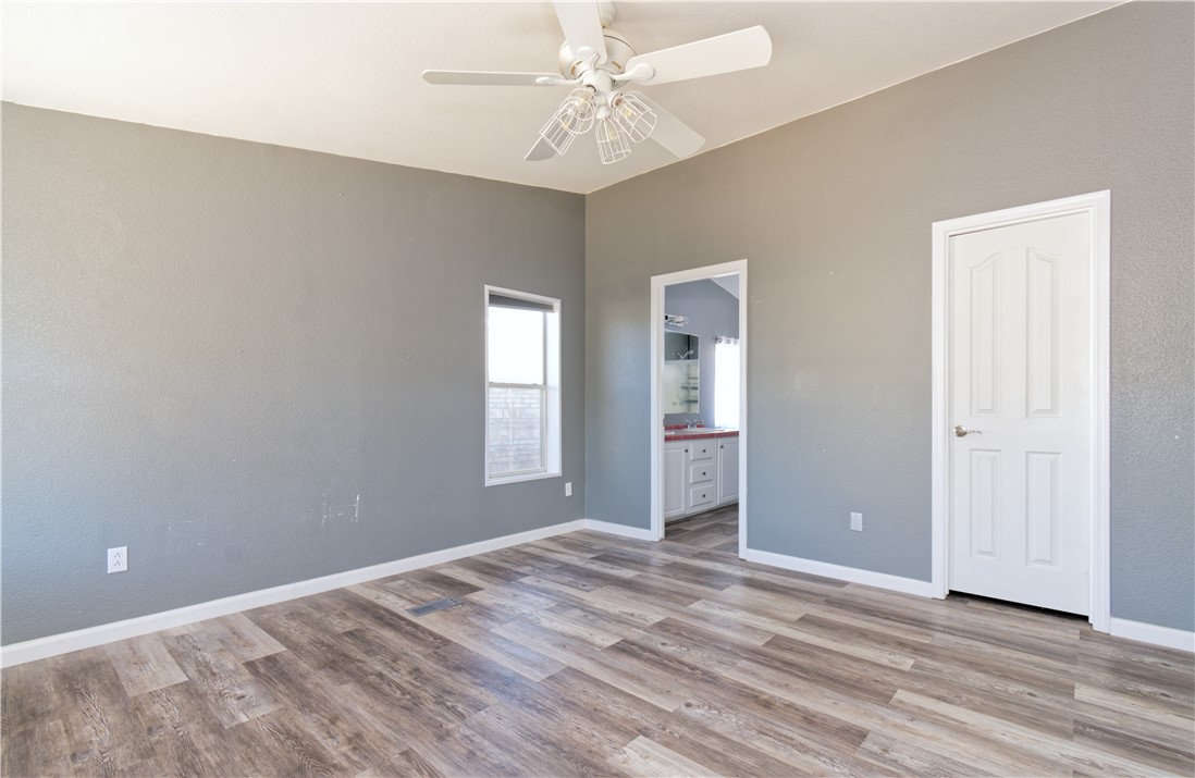 49603 Rainbow Avenue Quartzsite, AZ 85346 - Photo 21 of 44 Unfurnished bedroom with light wood-type flooring, ensuite bath, and ceiling fan