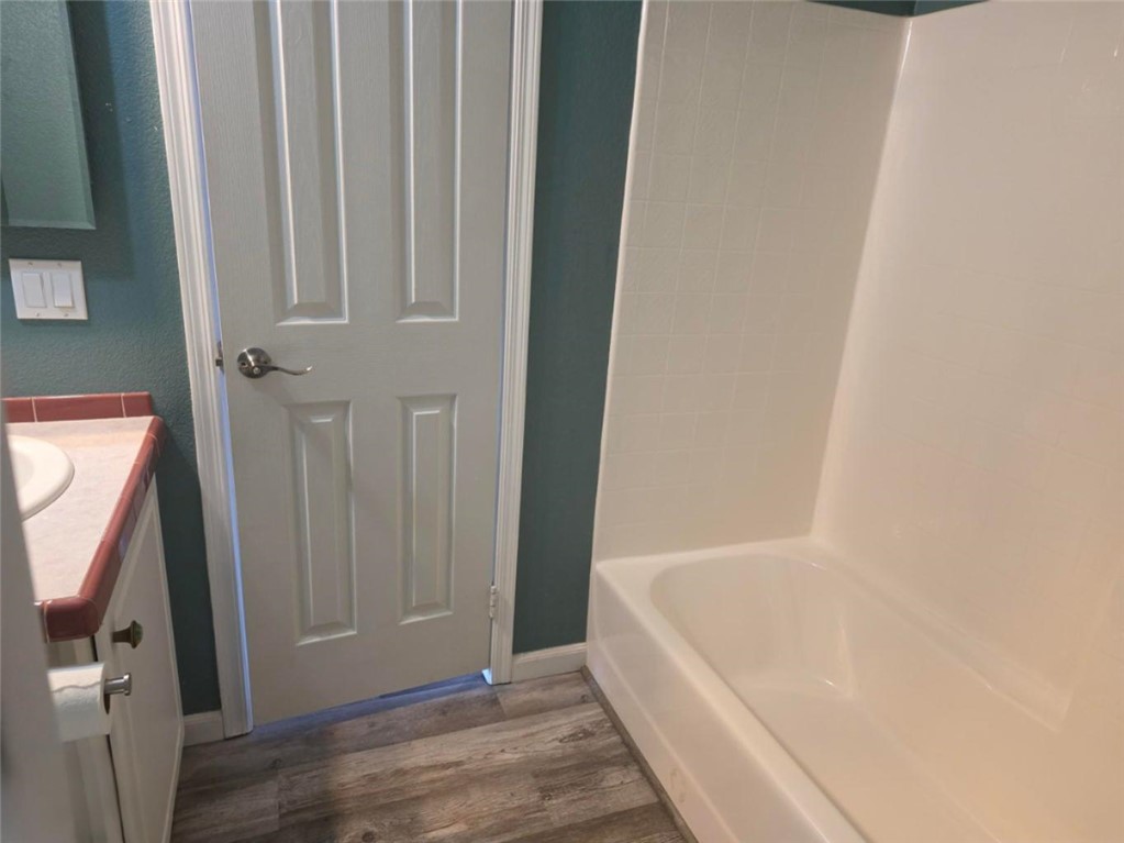49603 Rainbow Avenue Quartzsite, AZ 85346 - Photo 26 of 44 Bathroom featuring vanity, dark wood finished floors, and bathtub / shower combination