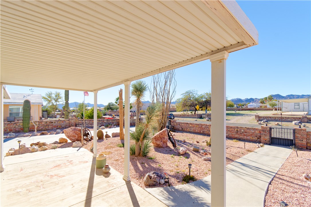 49603 Rainbow Avenue Quartzsite, AZ 85346 - Photo 30 of 44 View of patio featuring a gate and a mountain view