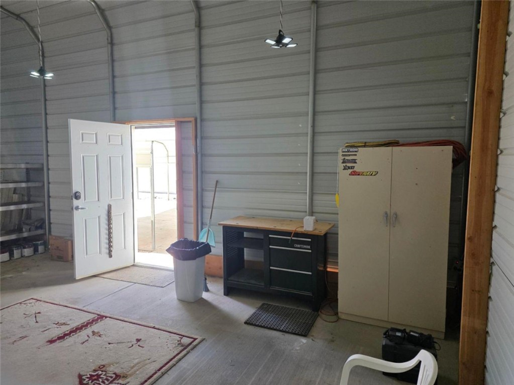 49603 Rainbow Avenue Quartzsite, AZ 85346 - Photo 35 of 44 Miscellaneous room with a garage, metal wall, and a high ceiling