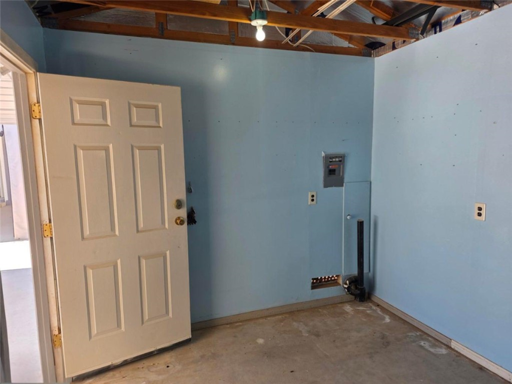 49603 Rainbow Avenue Quartzsite, AZ 85346 - Photo 38 of 44 Laundry room with unfinished concrete floors and electric panel