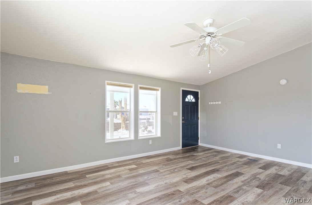 49603 Rainbow Avenue Quartzsite, AZ 85346 - Photo 8 of 44 Foyer entrance featuring ceiling fan, light wood finished floors, and lofted ceiling