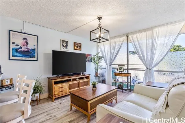 a living room with furniture a flat screen tv and a large window