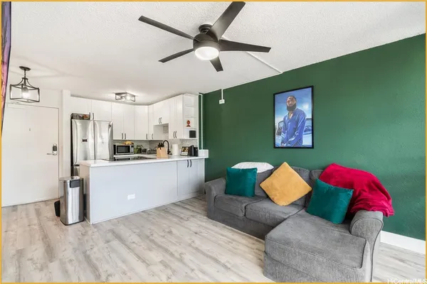 a living room with stainless steel appliances kitchen island furniture and a view of kitchen