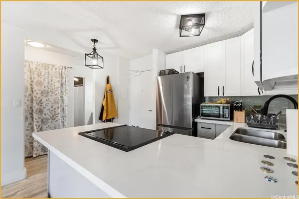 a kitchen with stainless steel appliances a refrigerator sink and a stove