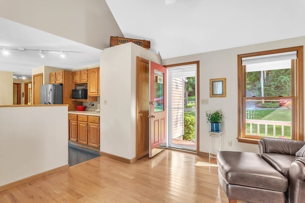 87 Cote Road Monson, MA 01057 - Photo 25 of 30 a living room with stainless steel appliances kitchen island granite countertop a refrigerator and wooden floor