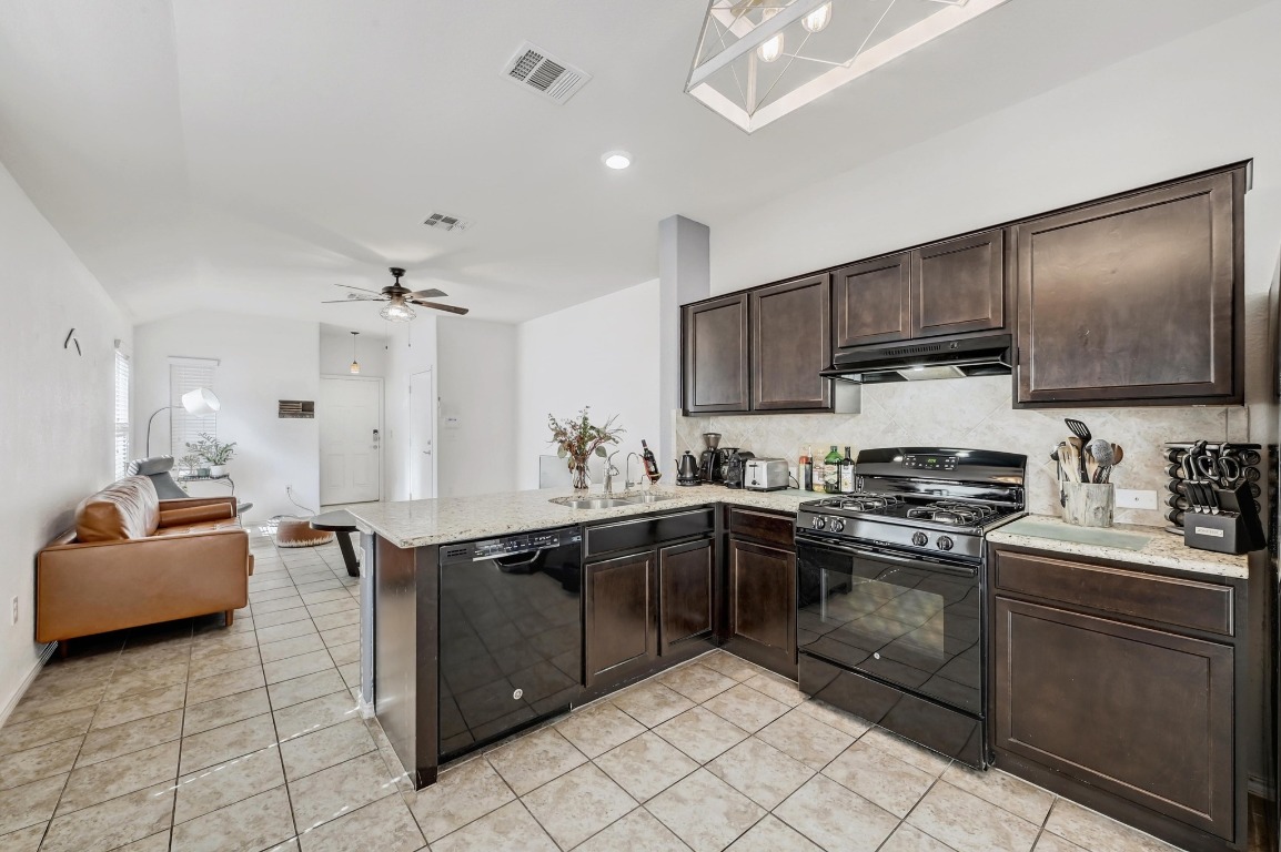 3525 Black Granite Drive Austin, TX 78744 - Photo 1 of 1 a kitchen with stainless steel appliances granite countertop a sink stove and cabinets