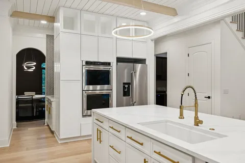 a bathroom with a tub sink and mirror