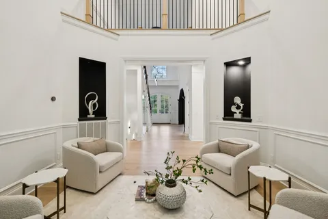 an empty room with a window and a ceiling fan