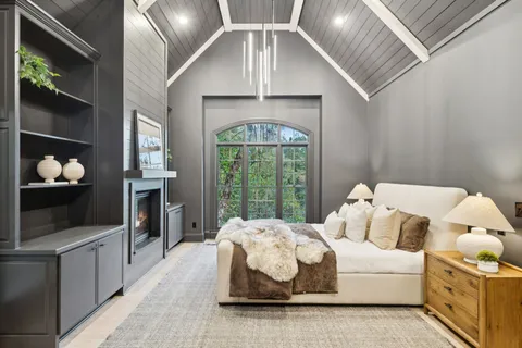 an empty room with a window and a ceiling fan